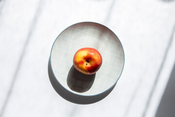 Sticker - An apple on a plate on a white background. Top view, flat lay