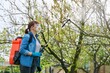 © Valerii Honcharuk - Woman with backpack garden spray gun under pressure handling peach tree