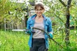 © Valerii Honcharuk - Woman gardener in gloves with hand garden saw and cut off dry branch of fruit tree