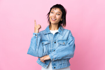 Wall Mural - Young Uruguayan woman over isolated pink background pointing up a great idea