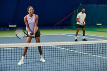 Full Length Portrait Of Smiling Black Woman Playing Tennis At Indoor Court, Copy Space