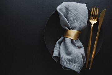 Golden cutlery set with dark plate