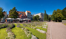 Livu Square In Riga, Latvia, Panoramic Image With Wave Pattern Of Flowerbeds On Foreground. The Square Was Once A Riverbed.