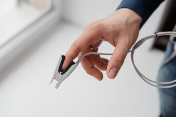 Pulse oximeter on a white background. Medical monitoring and diagnostic device for non-invasive measurement of capillary blood oxygen saturation