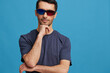 © SHOTPRIME STUDIO - Cheerful man in blue t-shirt 3d glasses entertainment gesture with hands blue background