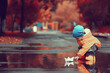 autumn in the park little boy walking in a raincoat seasonal look
