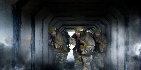 Wall Mural - Photo format 2x1.Three military mercenaries during special operation against the background of a concrete tunnel and smoke.