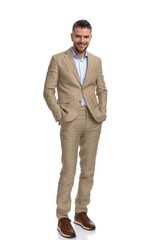 Wall Mural - happy businessman in beige suit holding hands in pockets