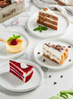 Composition with assorted cakes. Set of dessert: cheesecake, red velvet, tiramisu, carrot cake. Popular dessert composition. Pieces of cakes: red velvet, tiramisu, cheesecake, carrot cake.