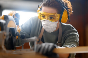 Wall Mural - woman carpenter in workshop