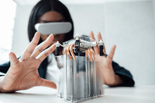 Engineer Wearing Virtual Reality Simulator Gesturing At Machine Part On Desk