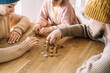 © Westend61 - Poor family with winter hats sitting at table counting coins