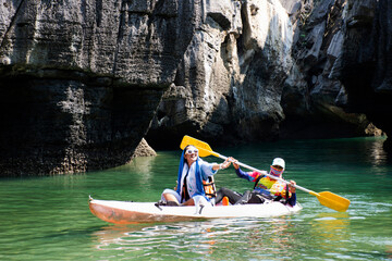 Local thai people guide paddle canoe boat of trip tour in sea ocean bring travelers women travel visit Prasat Hin Pan Yod in Mu Ko Petra National Park at Pak Bara on April 12, 2022 in Satun, Thailand