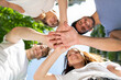© Minerva Studio - Group of friends putting their hands together