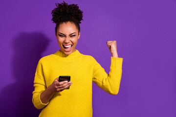 Sticker - Portrait of delighted successful girl raise fist celebrate follow isolated on purple color background