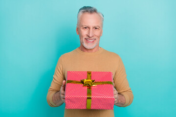 Wall Mural - Portrait of handsome good mood cheerful male give you birthday present wrapper box isolated on teal color background