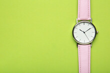 Pink Wrist Watches On Green Background With Copy Space