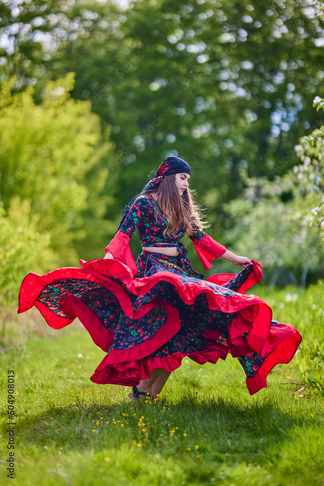 beautiful woman in traditional gypsy dress posing in nature in spring Stock Photo | Adobe Stock beautiful woman in traditional gypsy dress posing in nature in spring Stock Photo | Adobe Stock