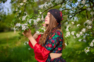 Wall Mural - beautiful woman in traditional gypsy dress posing in nature in spring