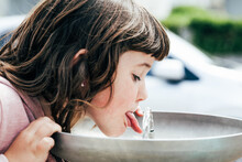 Girl Drinking Water From Fountain