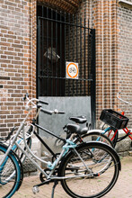 Bikes Parked On Sidewalk Near Brick Wall