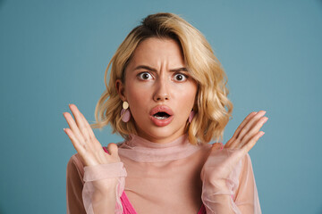 Wall Mural - Young white woman gesturing while expressing surprise at camera