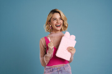 Wall Mural - Young woman laughing while posing with stuffed exercise book