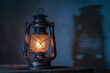 antique kerosene lamp with lights on the wooden floor in the gray old plaster background.