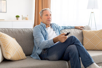 Canvas Print - Mature guy spending weekend watching tv at home