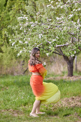 portrait of a woman in a dress in nature on a beautiful spring day