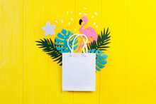 Mockup Summer Tropical Leavess With Flamingo Bird On Yellow Wooden Background. Jungle Palm And Monstera Leaves With Package Copyspace For Greeting Card