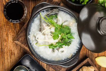 Wall Mural - Chinese cuisine; Congee with fish slices in casserole