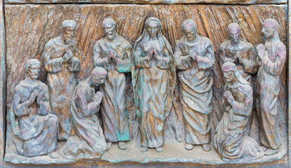 Wall Mural - MONOPOLI, ITALY - MARCH 6, 2022: The bronze relief  the Pentecost on the gate of church Chiesa di Sacro Cuore by Wolfgang Stempfele from year 2002.