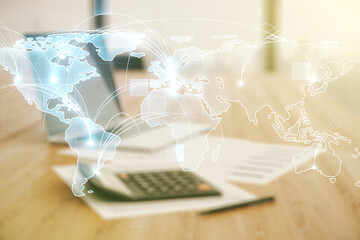 Wall Mural - abstract graphic digital world map hologram with connections on blurry calculator and computer backg