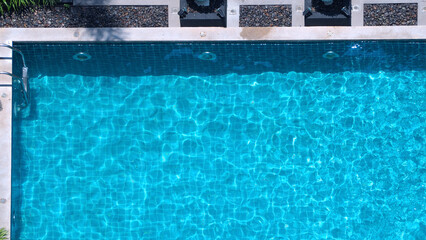 Wall Mural - Bird eyes view images of hotel swimming pool salt system not clorine which have blue clear color water and good for health and relaxing in summer vacation day on Bangkok Thailand