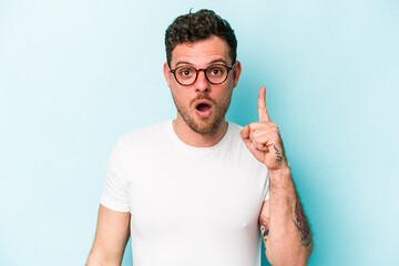 Young caucasian man isolated on blue background having some great idea, concept of creativity.