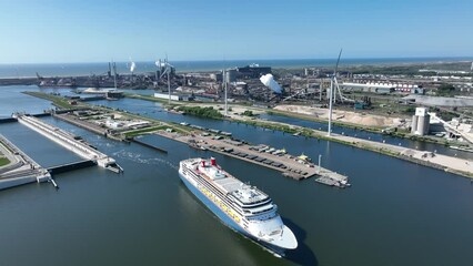 Wall Mural - 4k aerial video of cruise ship leaving large sea sluice towards Amsterdam in the Netherlands. Tata steel factory in the back ground