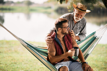 Wall Mural - Happy senior man and his son enjoy in day they are spending in nature.