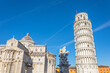 Pisa cathedral and the leaning tower and sculpture in a sunny day in Pisa, Italy.