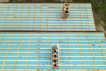 Wall Mural - Aerial view of a wooden roof frame of brick house under construction.