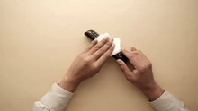 Cleaning Tv Remote Control With An Antibacterial Fabric Tissue..