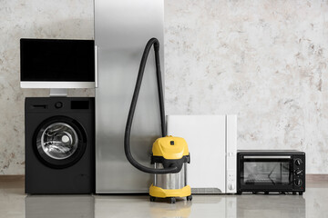 Wall Mural - Different household appliances near light wall