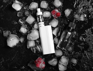 Modern vape mod, berries and ice cubes on black background