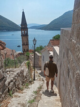 Man Walking Downstairs To The Sea In Old Town Perast, Montenegro