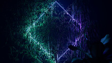 Green And Purple Neon Light With Tropical Plants. Diamond Shaped Fluorescent Frame In Nature Environment.