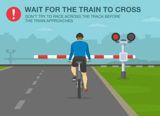 Wall Mural - Safe bicycle riding rules and tips. Wait for the train to cross, don't try to race across the track before the train approaches. Back view of a cyclist at railroad crossing.