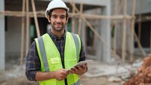 Smart Male Engineer Specialist With Safety Uniform Holding Tablet To Work Making A Check And Inspect On Construction Building Looking At Camera With Smile, Engineering Working With Happiness Concept
