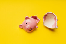 Broken Piggy Bank On A Yellow Background