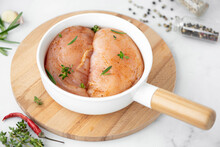 Raw Chicken Fillet With Spices And Rosemary In A Round Baking Sheet