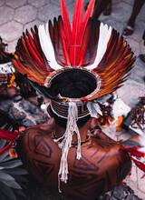 Indigenous Man From A Brazilian Amazon Tribe Wearing Colourful Feather Headdress Known As Cocar. Xingu River, Amazon, Brazil. 2009.